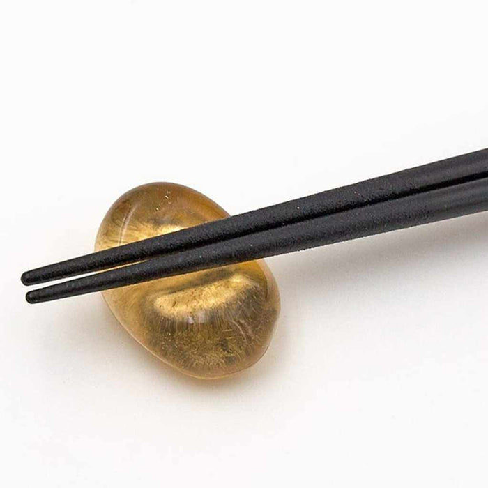 Black lacquer chopsticks resting on a gold leaf glass chopstick rest | Kanazawa gold leaf, Hakuichi