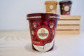 Hoggin' Dogs ice cream container with bacon flavor on a white surface.|Pot de glace Hoggin' Dogs au goût bacon.