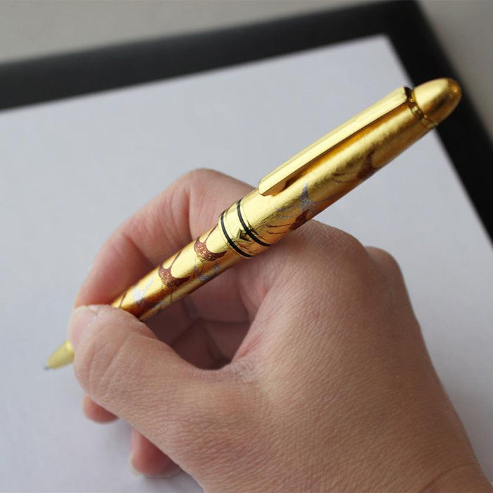 Gold leaf makie ballpoint pen held in hand, writing on paper | Hakuichi, Kanazawa