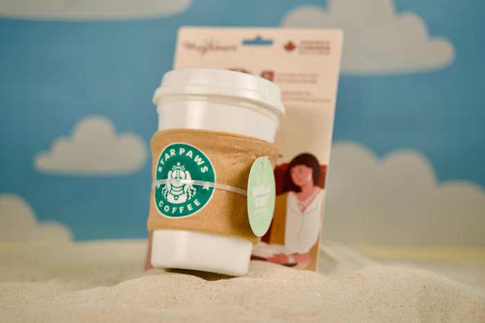 Coffee Time dog toy resting on a sunny sandbank, ready for beachside play.|Jouet pour chien Coffee Time posé sur un banc de sable ensoleillé, prêt pour jouer à la plage.