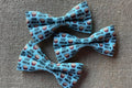 Two blue small pets bow ties with Stud Muffin pattern.|Deux petits nœuds papillon bleus pour animaux, à motif Stud Muffin.