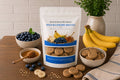 Baxter Bailey Wild Blueberry Biscuits handcrafted dog treats made with real blueberries and oat flour in a resealable bag.|Biscuits pour chiens aux myrtilles sauvages et farine d'avoine, présentées dans un sachet refermable.